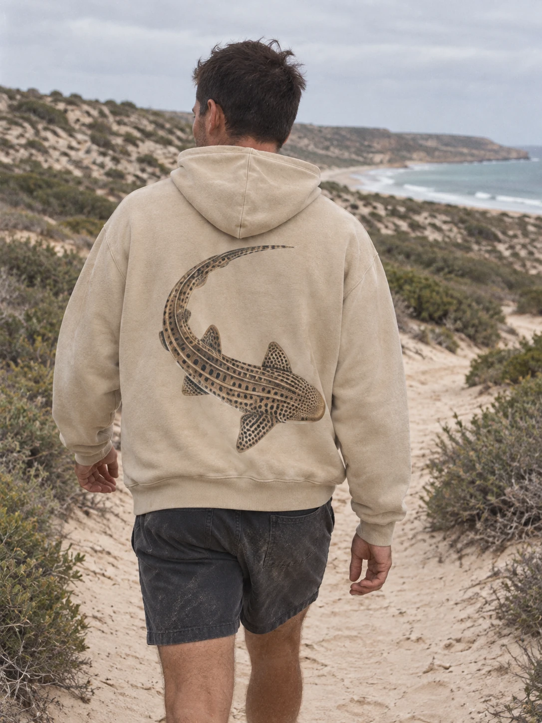 Leopard shark hoodie in washed sand, worn on the Australian coast